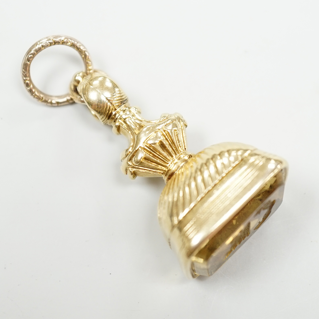 An early 19th century gold overlaid fob seal, the matrix carved with a boars head crest and motto, height 4cm